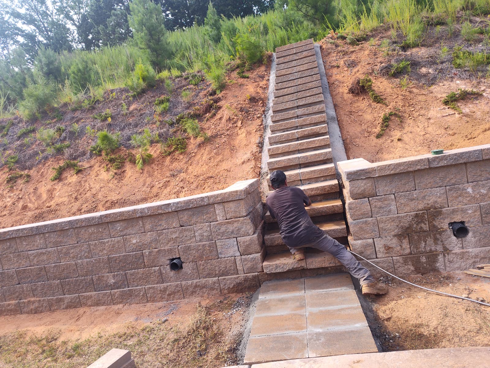 Professional construction of retaining walls and outdoor stairways on sloped terrain